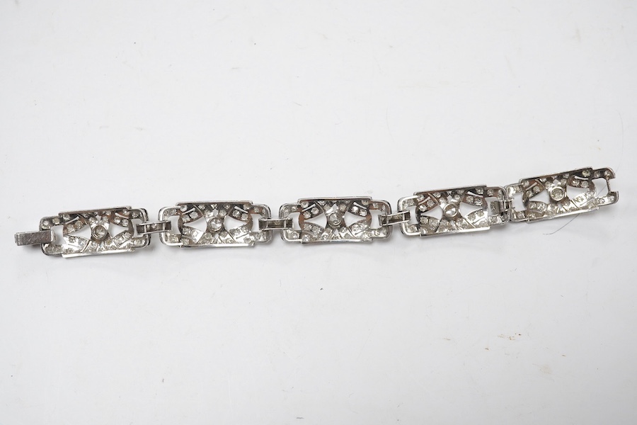 An early 20th century pierced platinum? and millegrain set diamond cluster bracelet, set with old round and eight cut stones, 17cm, gross weight 22.8 grams. Condition - fair to good